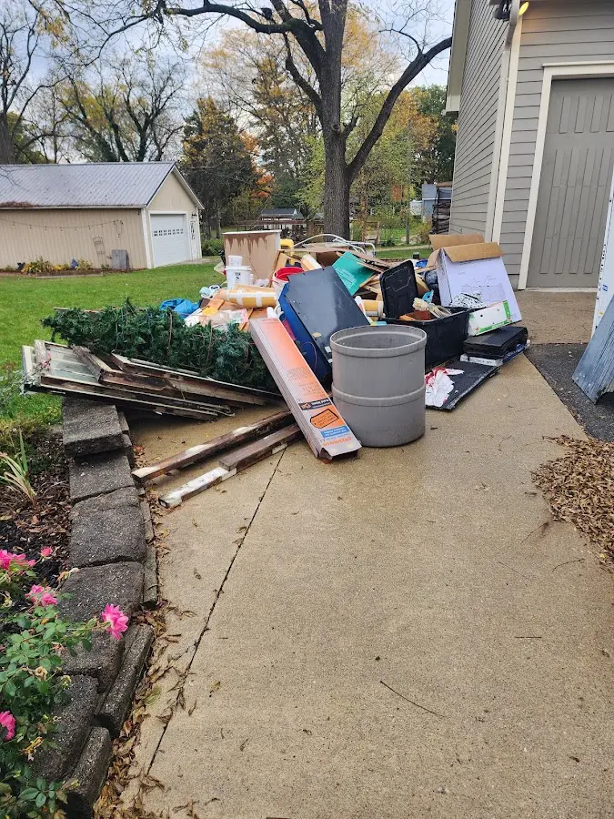 Dumpster being loaded with debris for 3 Yard Dumpster Rental in Victor